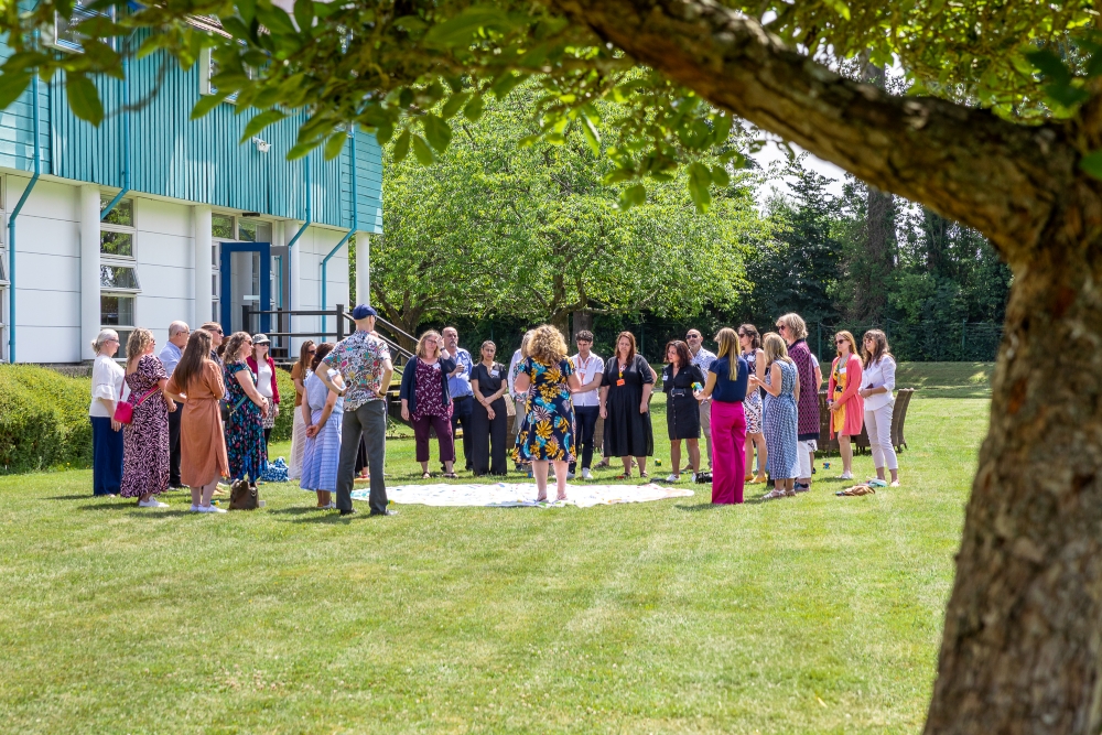 Corporate delegates participating in an outdoor team-building activity on the spacious green grounds at CIM Business Centre.