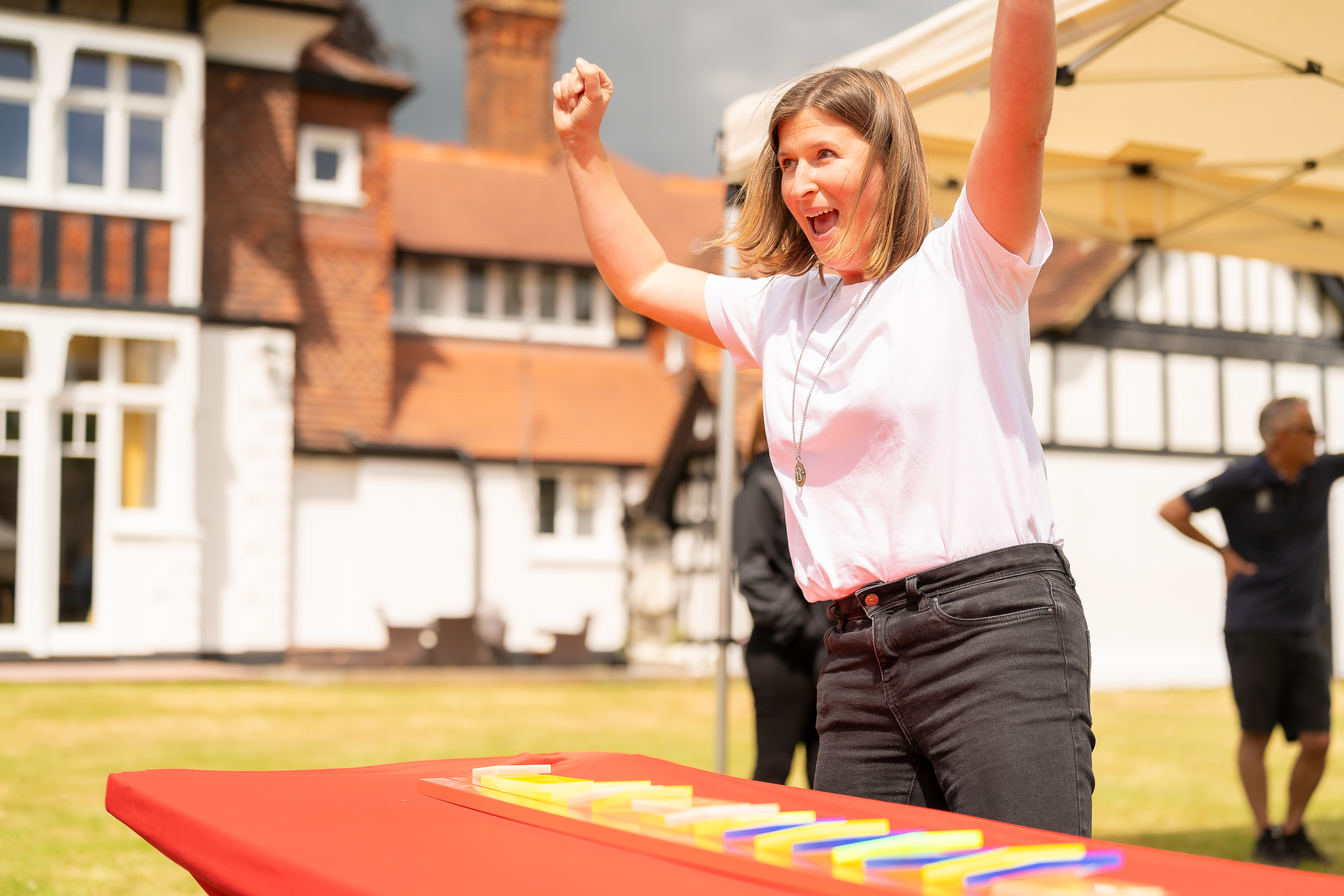 Participant celebrating during an outdoor team building activity on the lawn at CIM Business Centre.